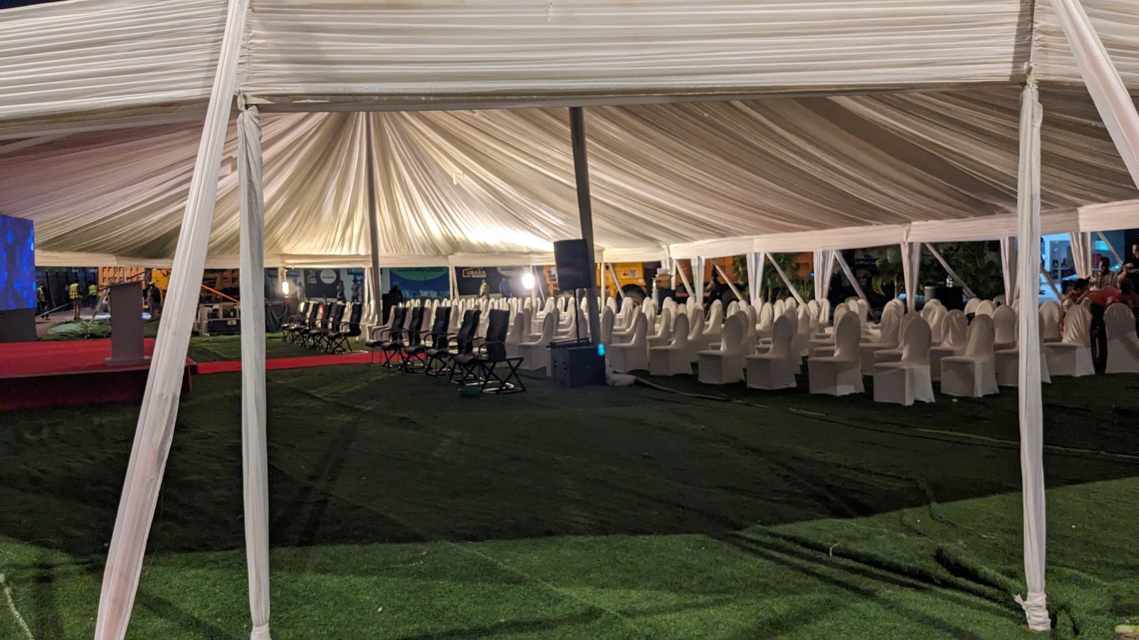 Tent interior with elegant draping and seating at night