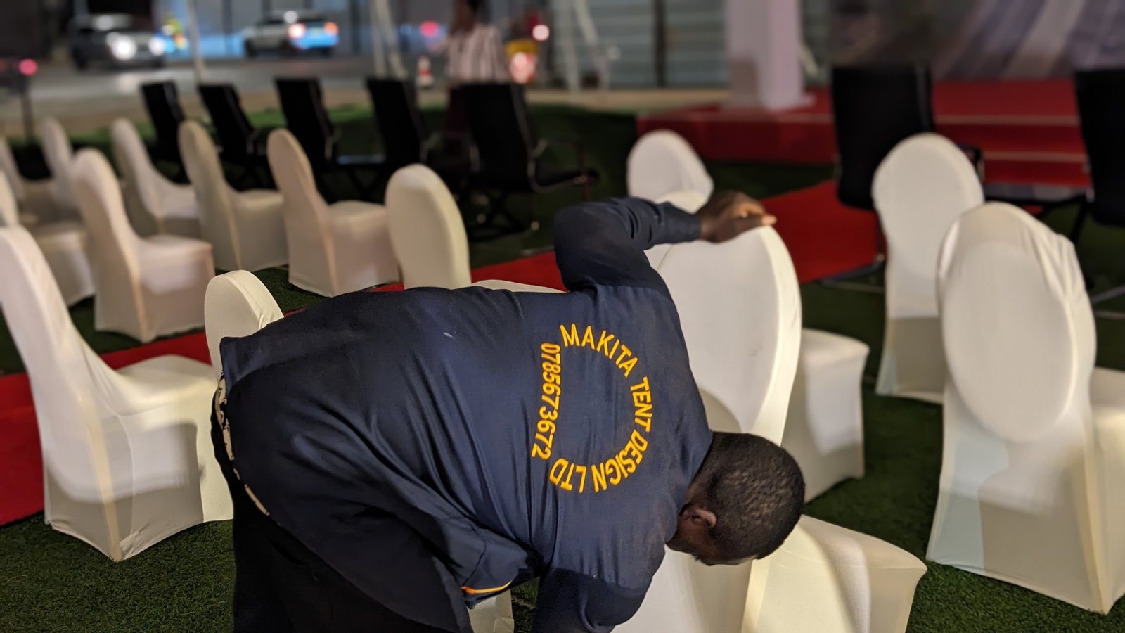 MAKITA crew in branded uniform setting up event chairs