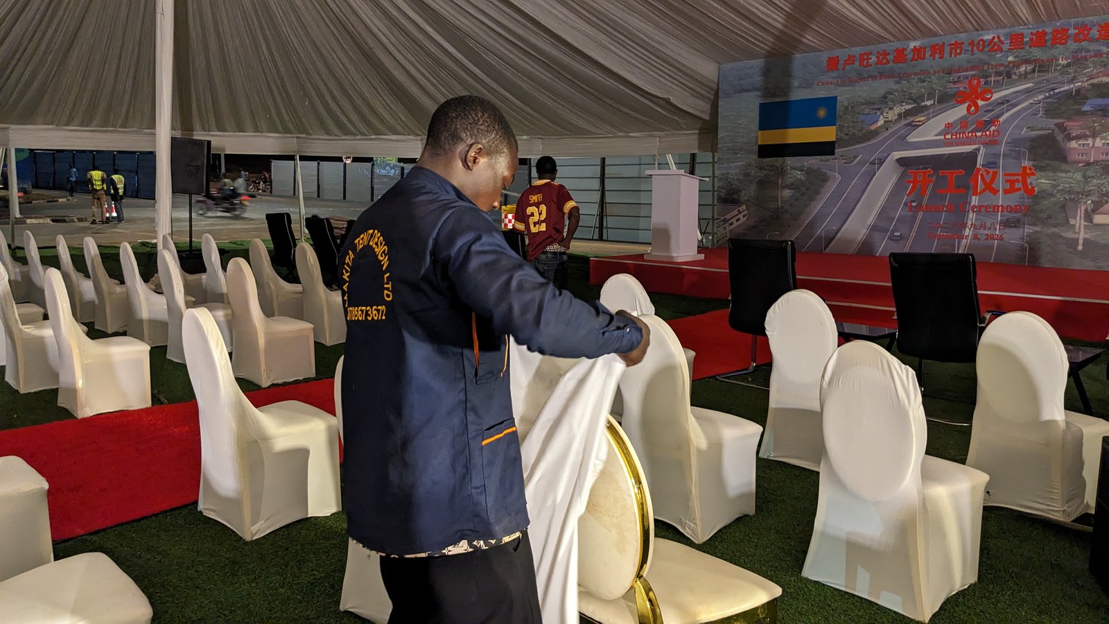 MAKITA Tent Design crew member setting up white chair covers at corporate event