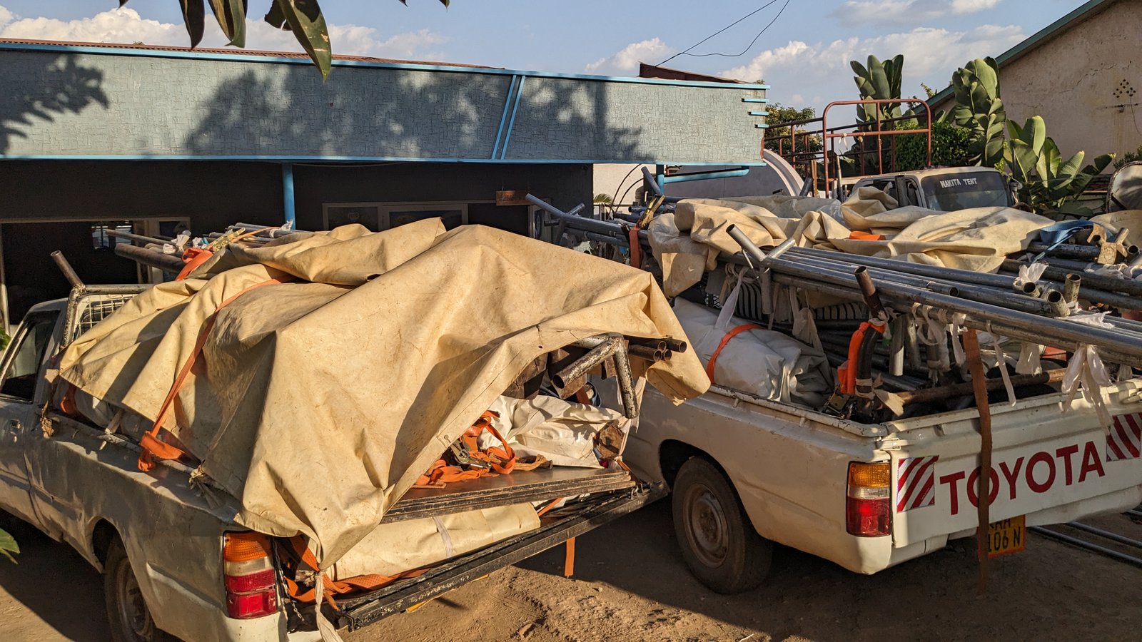 MAKITA delivery trucks loaded with tent equipment