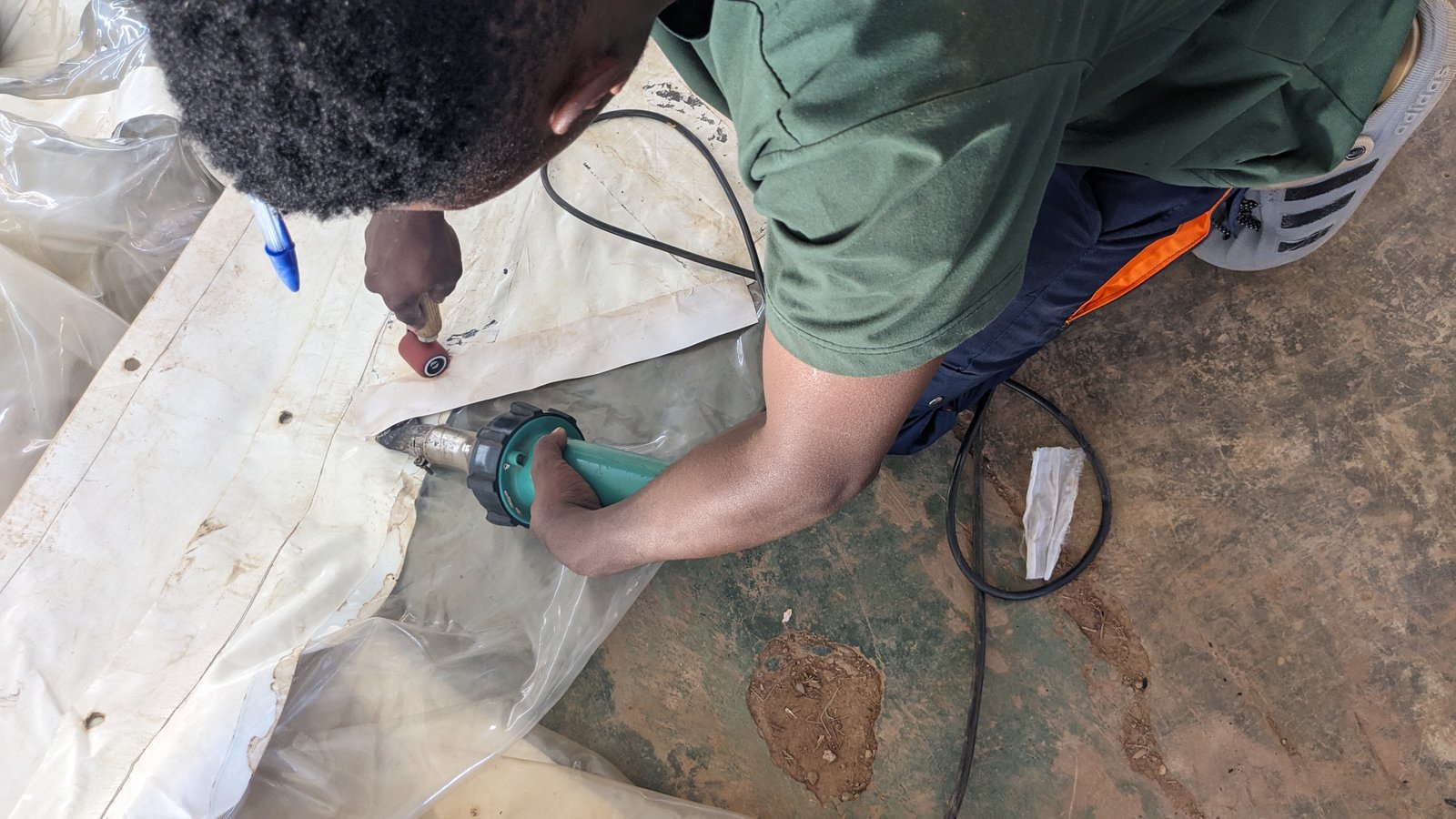 MAKITA technician heat-welding a tent seam during repair